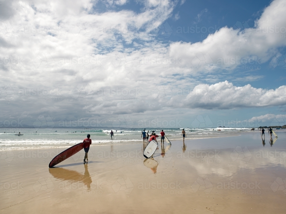 Longboard surfers walking to a surf break - Australian Stock Image