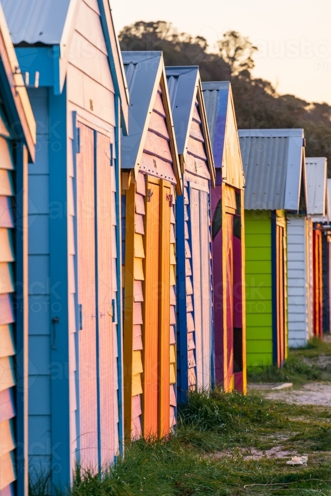 Looking along a row of colorful timber bathing boxes - Australian Stock Image