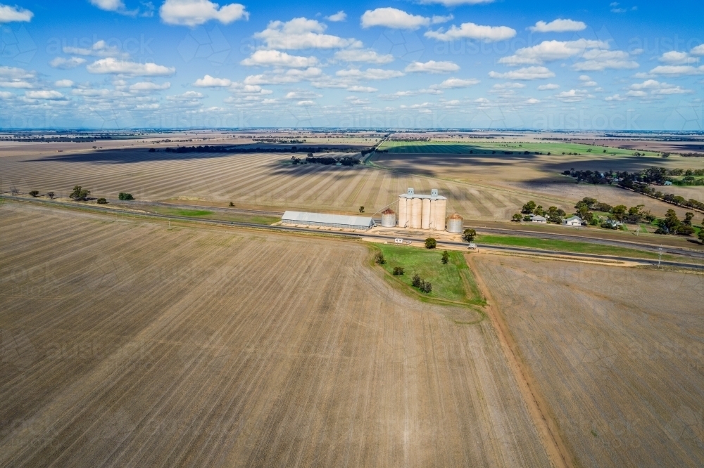 Looking at the silos, grain storage and the railway line in the remote area of Mallee - Australian Stock Image