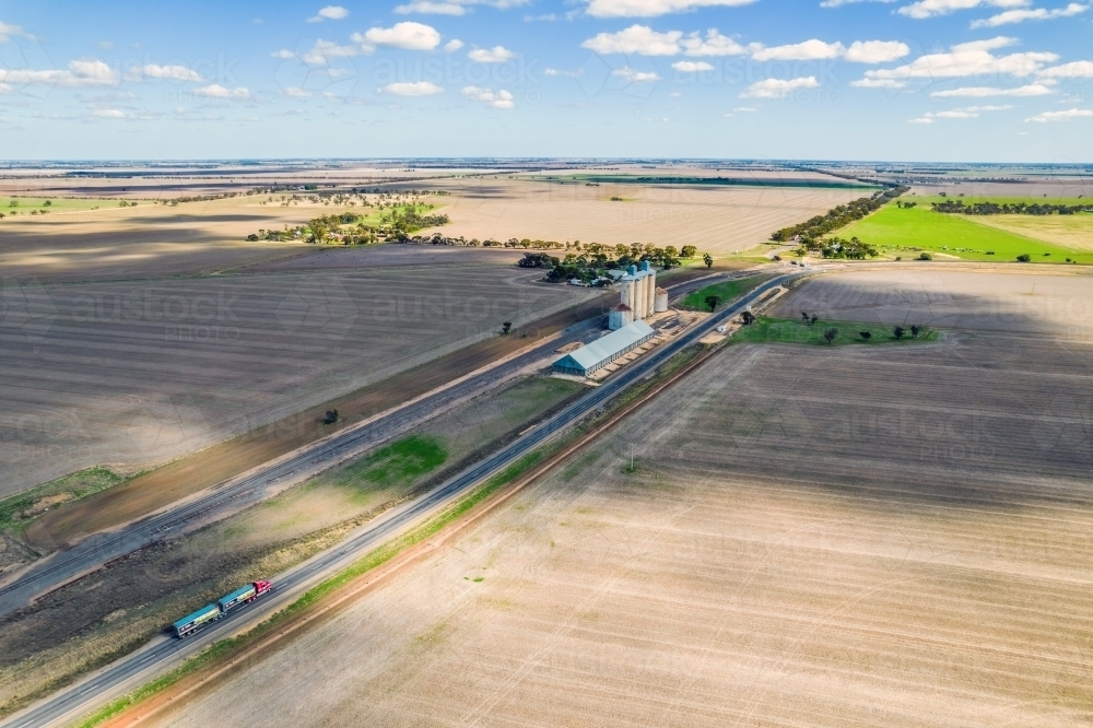 Looking at the silos, grain storage and the railway line in the remote area of Mallee - Australian Stock Image