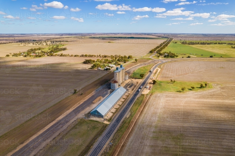 Looking at the silos, grain storage and the railway line in the remote area of Mallee - Australian Stock Image