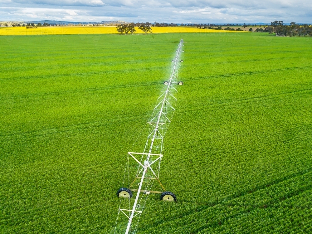 Image of Looking down on a large irrigation sprinkler in a green ...