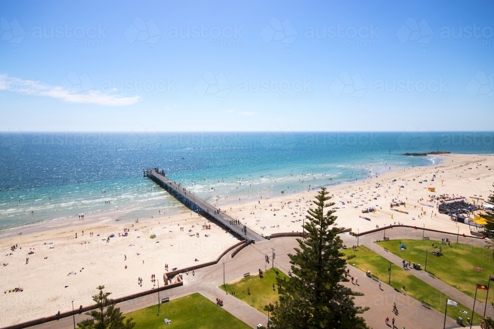 Looking down on busy beach with jetty - Australian Stock Image