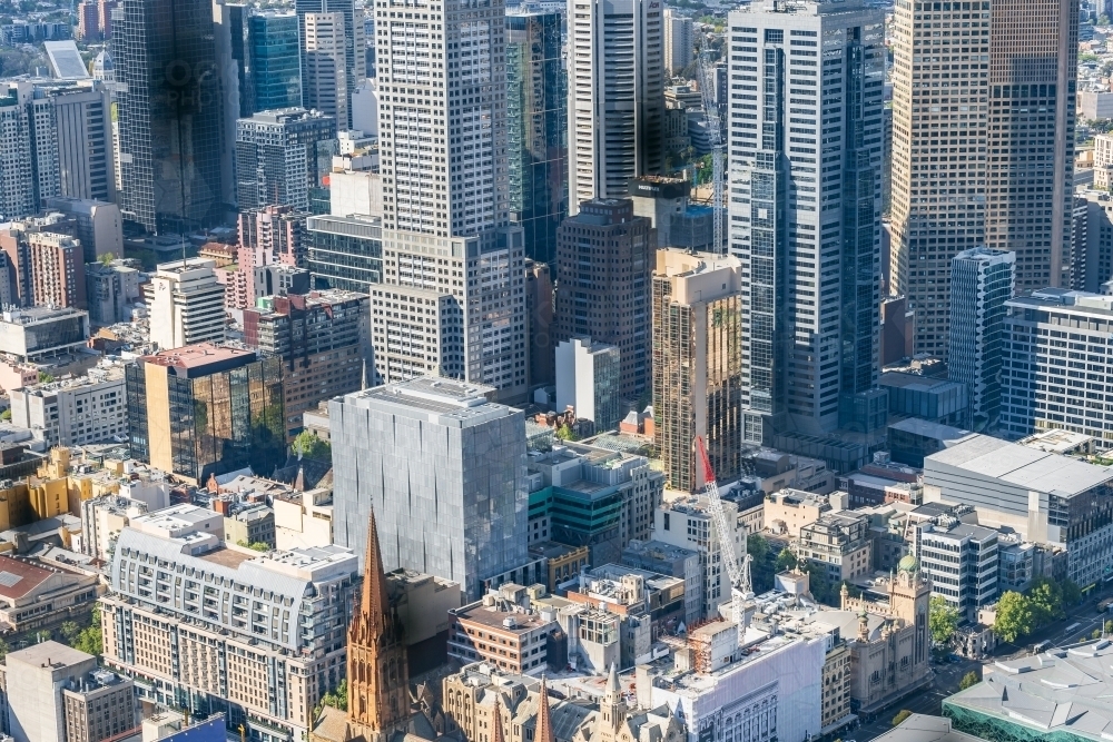 Looking down on tightly packed city buildings of varying heights and architecture - Australian Stock Image