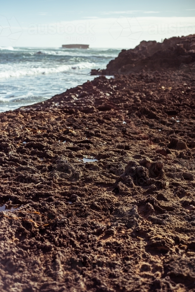 Looking out over rocky surface to ocean - Australian Stock Image