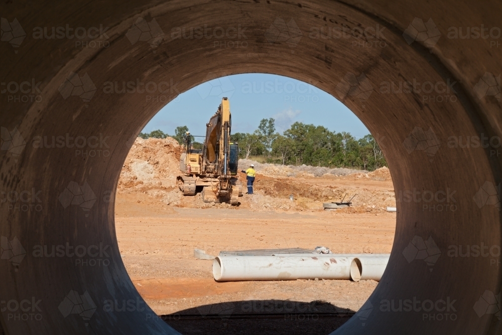 Looking through a drain pipe at an industrial building site - Australian Stock Image