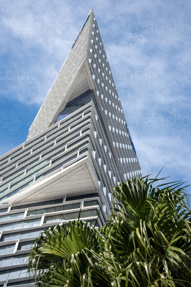 Looking up at a modern sky-scraper building on a sunny day - Australian Stock Image