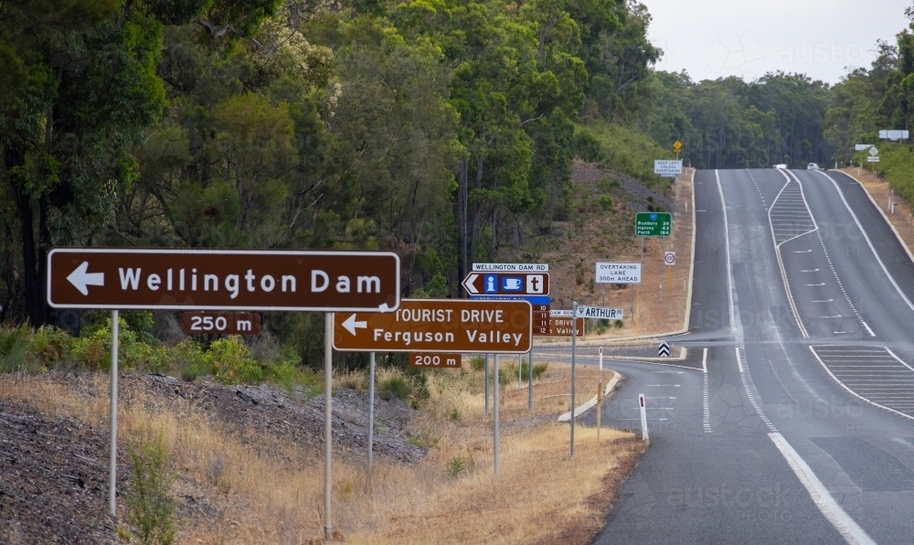 lots of road signs on side of highway at the Wellington Dam turn off - Australian Stock Image