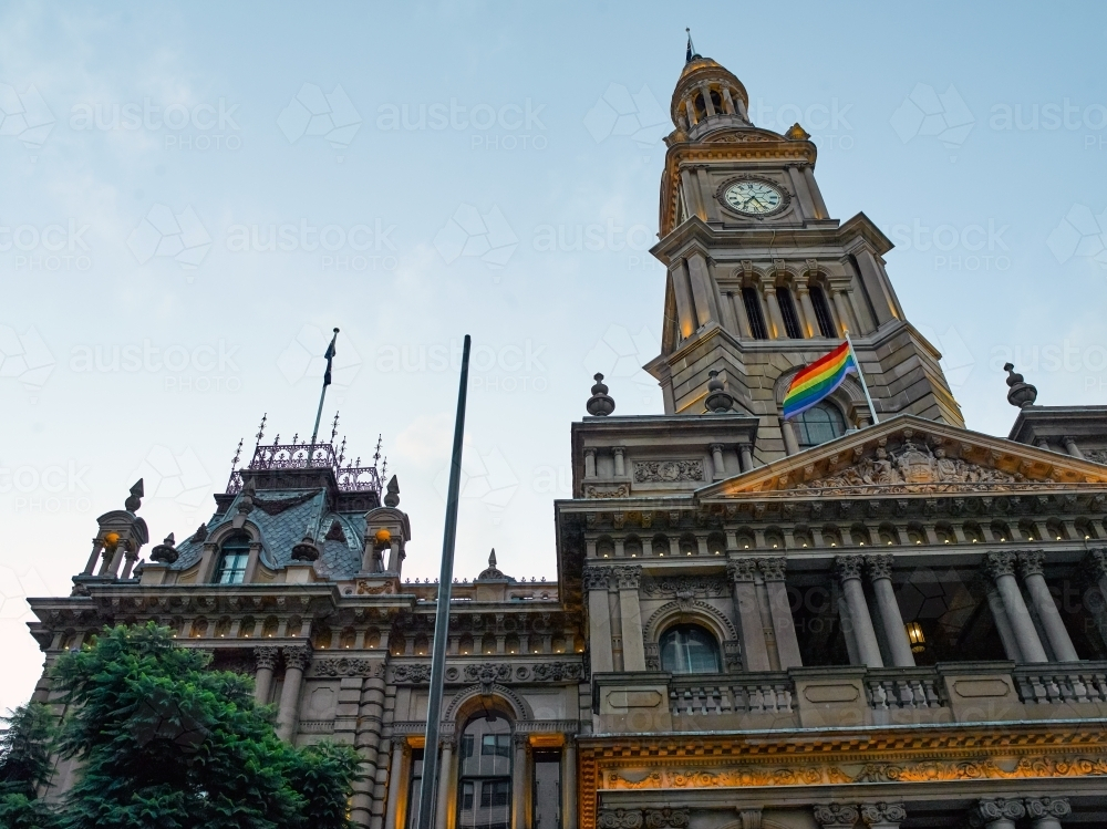 Low-angle shot of Sydney Town Hall with pride flag - Australian Stock Image