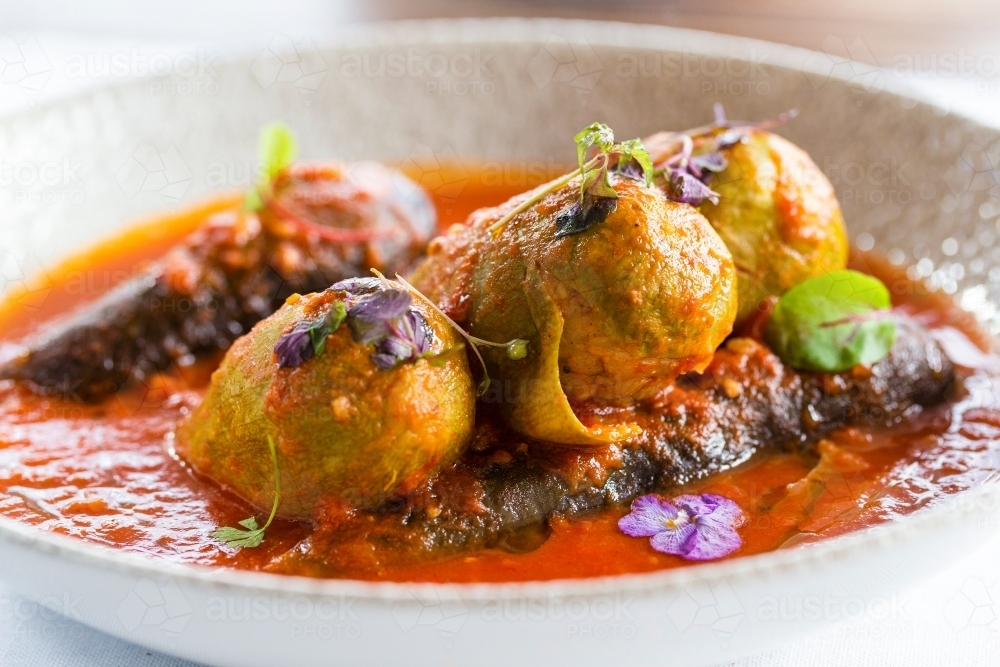 Mahashi with rich tomato sauce served in a white deep dish. - Australian Stock Image