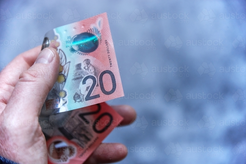 Male hand holding Australian 20 dollar bill - Australian Stock Image