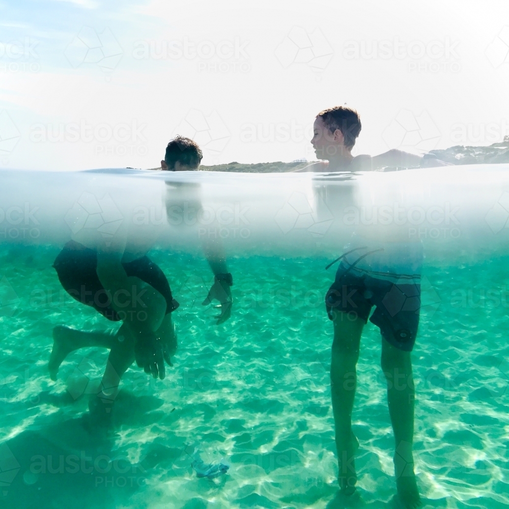 Man and Boy under and above water exploring - Australian Stock Image