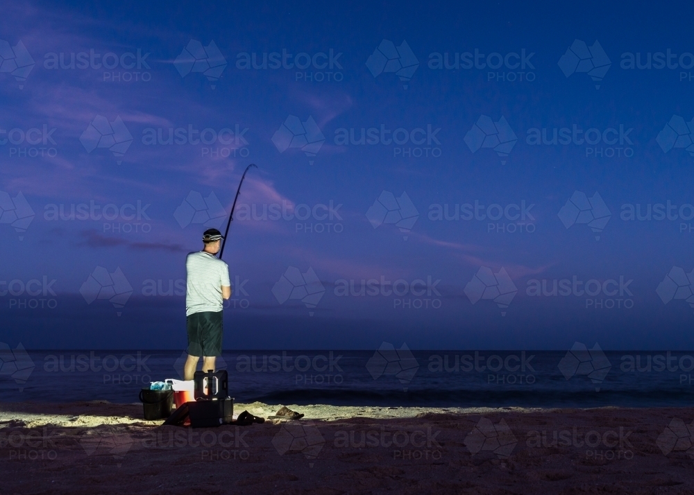 Man Beach Fishing in the Early Morning - Australian Stock Image