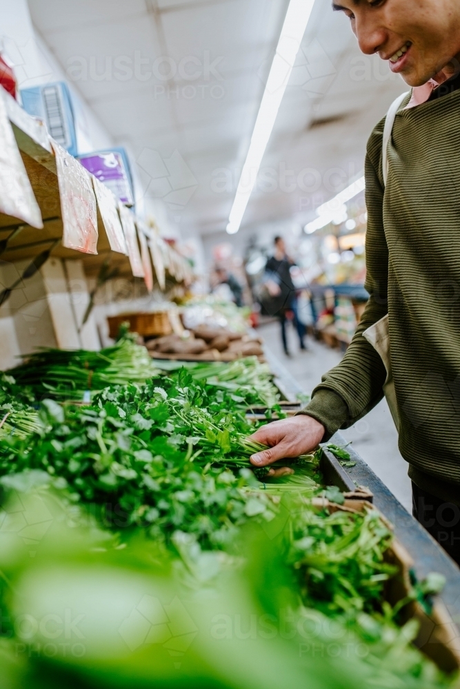 Man buying fresh produce at supermarket - Australian Stock Image