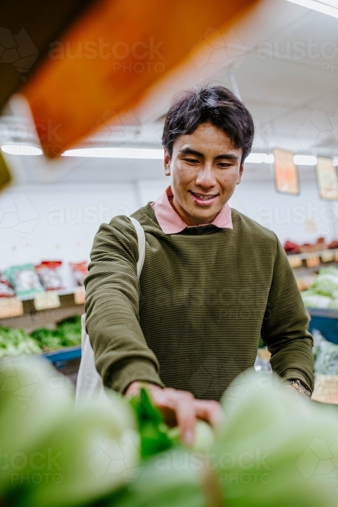 Man buying fresh produce at supermarket - Australian Stock Image