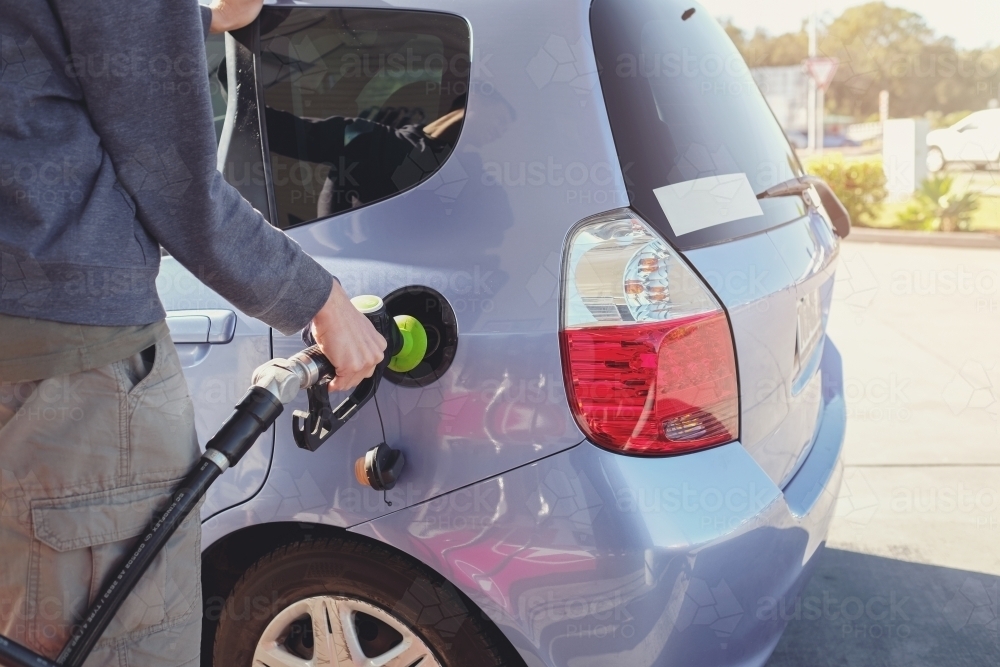 Man filling up car at petrol station with petrol - Australian Stock Image