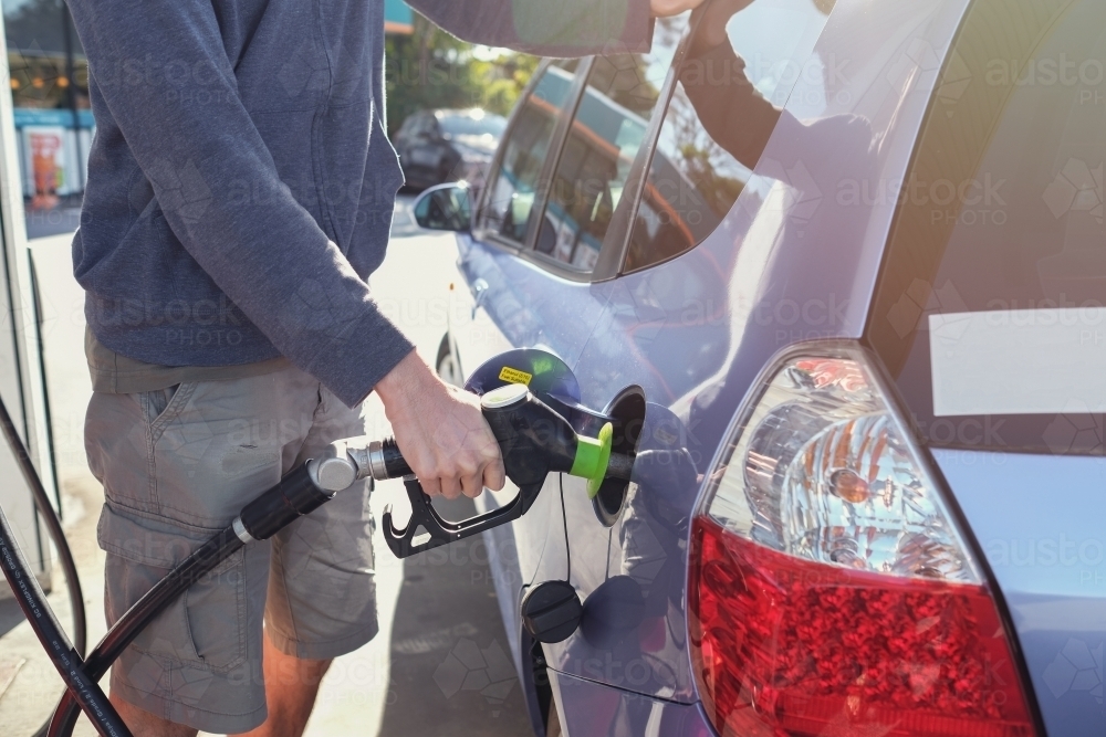 Man filling up car at petrol station with petrol - Australian Stock Image