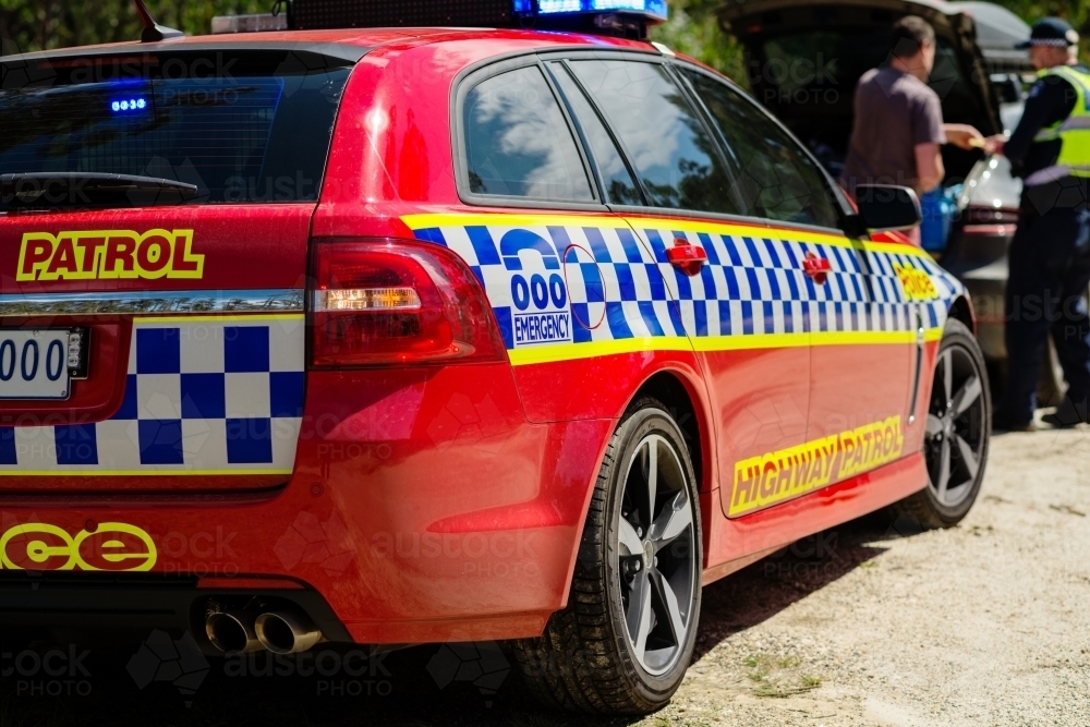 man giving police officer his license - Australian Stock Image