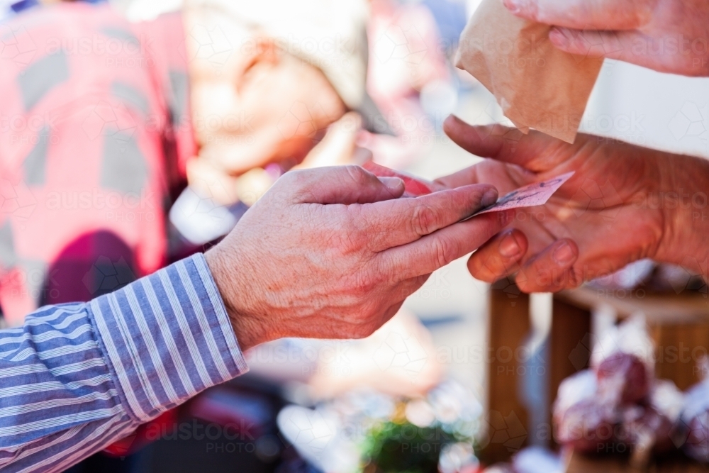 Man handing over twenty dollar note making cash payment - Australian Stock Image