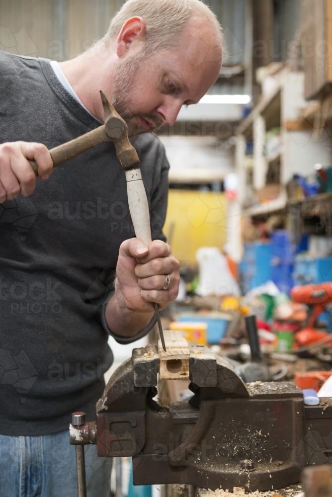 Man learning woodwork in the shed - Australian Stock Image