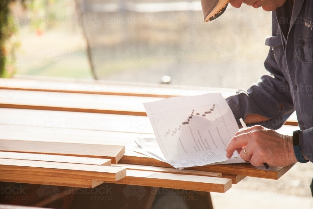 Man looking at building plans - Australian Stock Image