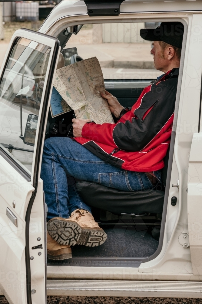 Man reading a map in the car in country - Australian Stock Image