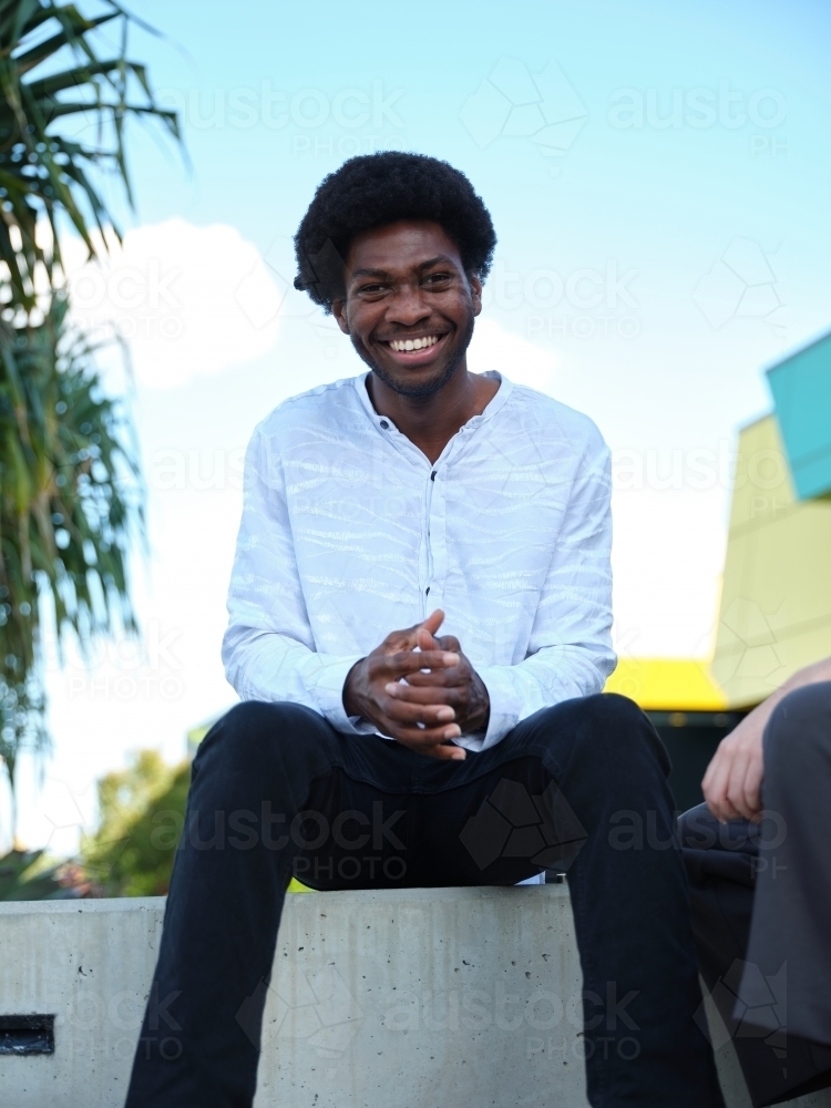 Man sitting on a concrete bench outside - Australian Stock Image