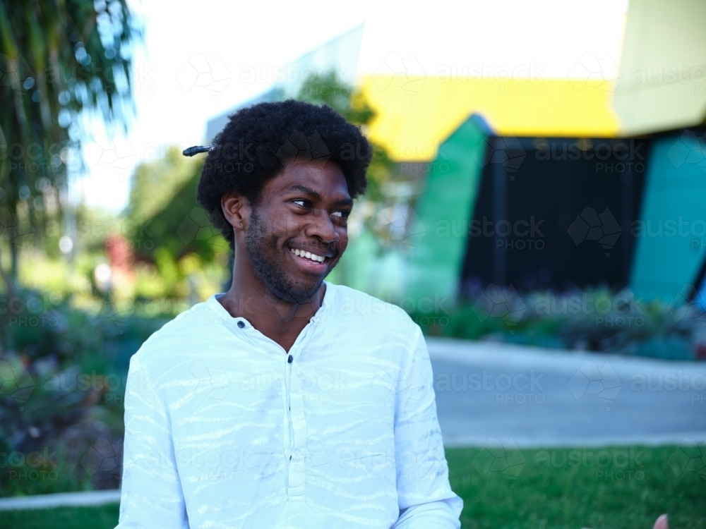 Man smiling at a park in the afternoon - Australian Stock Image