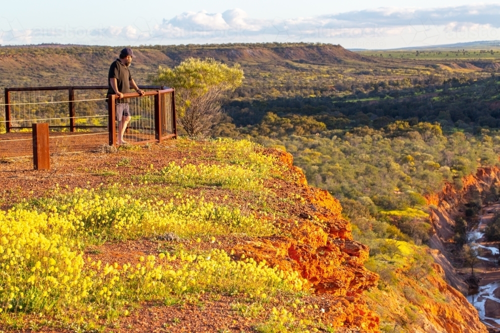 Man standing at lookout enjoying the view - Australian Stock Image