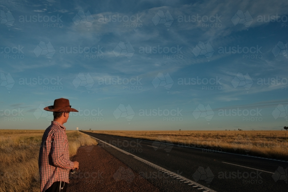 Man standing on the side of the road near Winton Queensland - Australian Stock Image