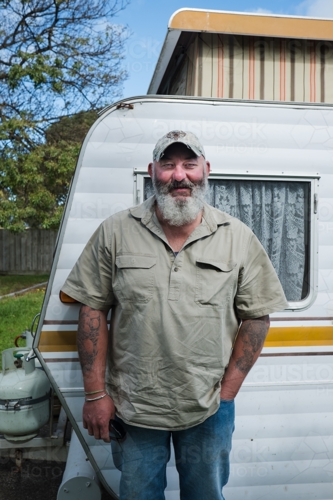 Man stands in front of his caravan. - Australian Stock Image