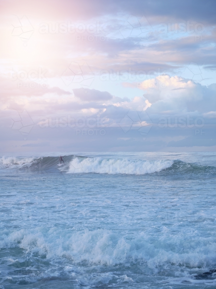 Man surfing over big waves on the beach - Australian Stock Image