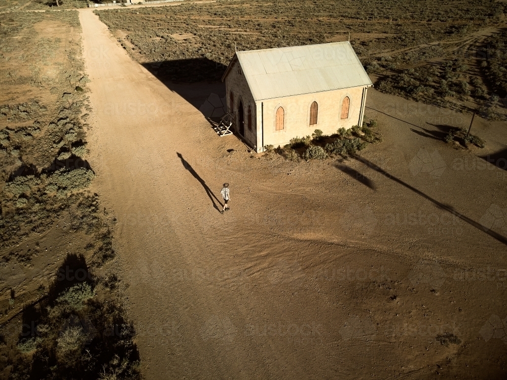 Man walking down the main street of Silverton, New South Wales - Australian Stock Image