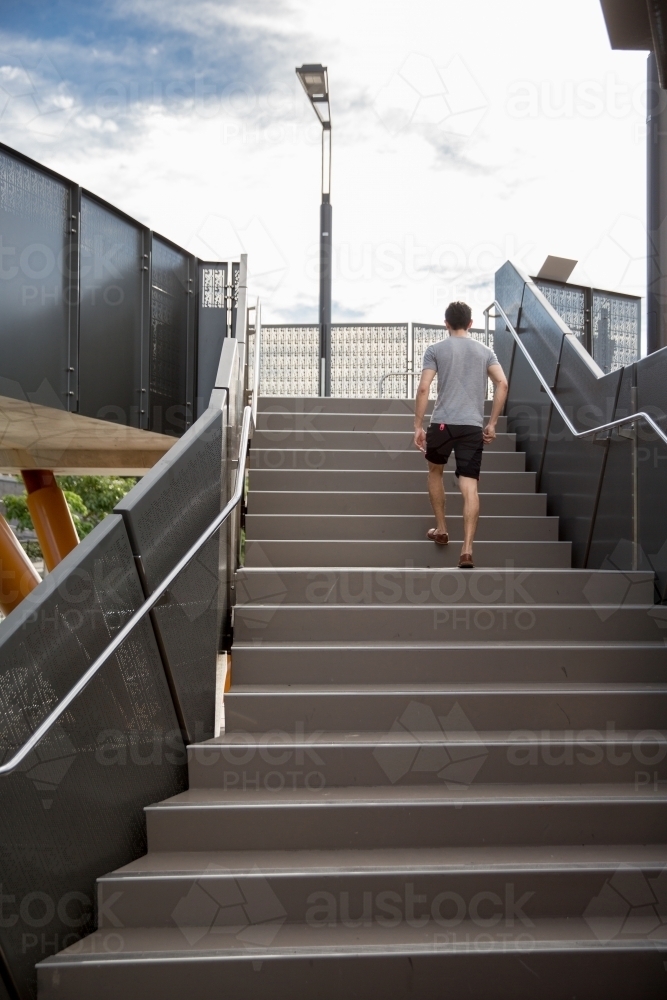 image-of-man-walking-up-stairs-austockphoto