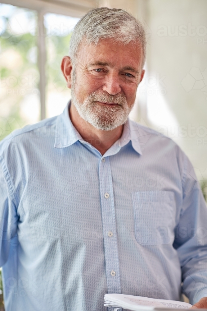 Image of happy older man wearing bucket hat and work clothes - Austockphoto