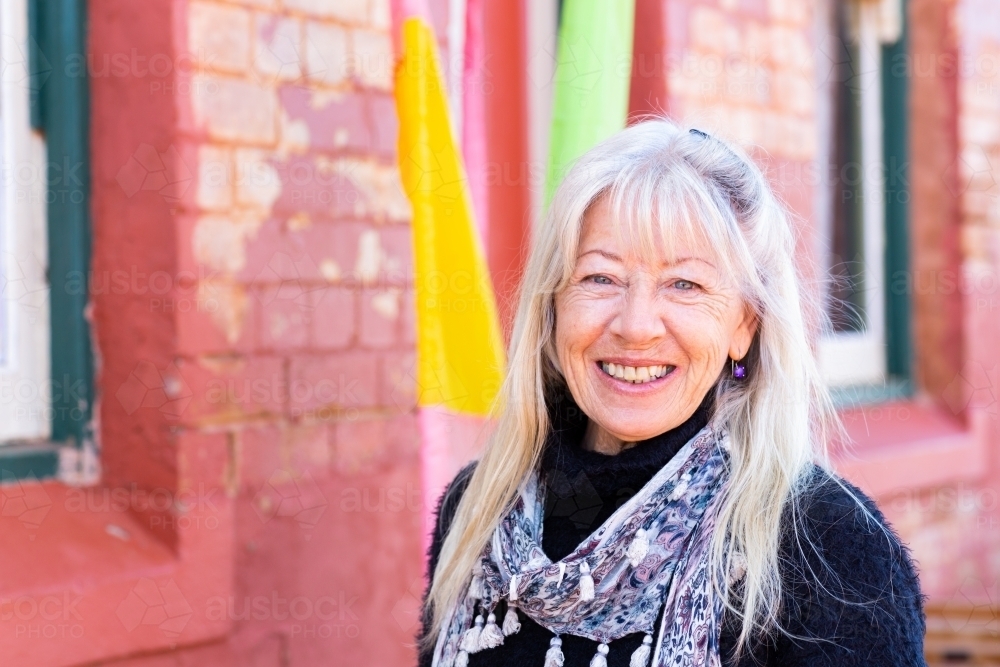 mature woman with long hair head and shoulders view looking at camera - Australian Stock Image