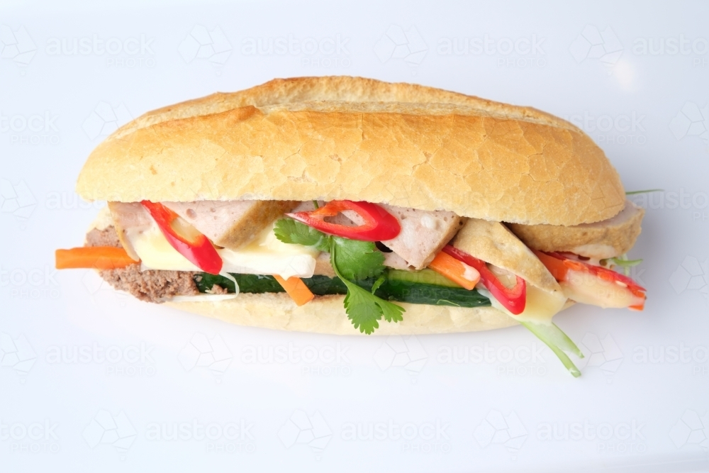 Meatloaf Bahn Mi filled with fresh herbs and vegetables. - Australian Stock Image