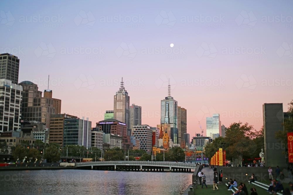 Melbourne city at sunset with river foreground - Australian Stock Image