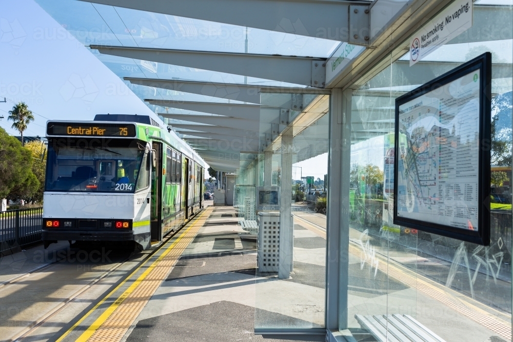 Melbourne public transport system - tram arriving at platform station - Australian Stock Image