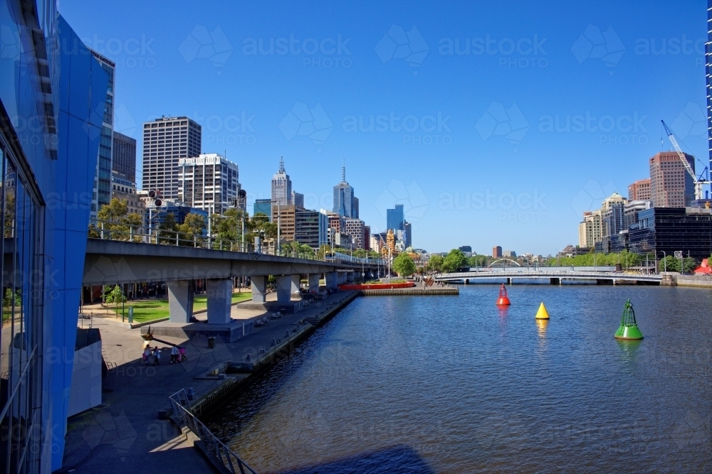 Melbourne Yarra river with oncoming train overlooking city - Australian Stock Image