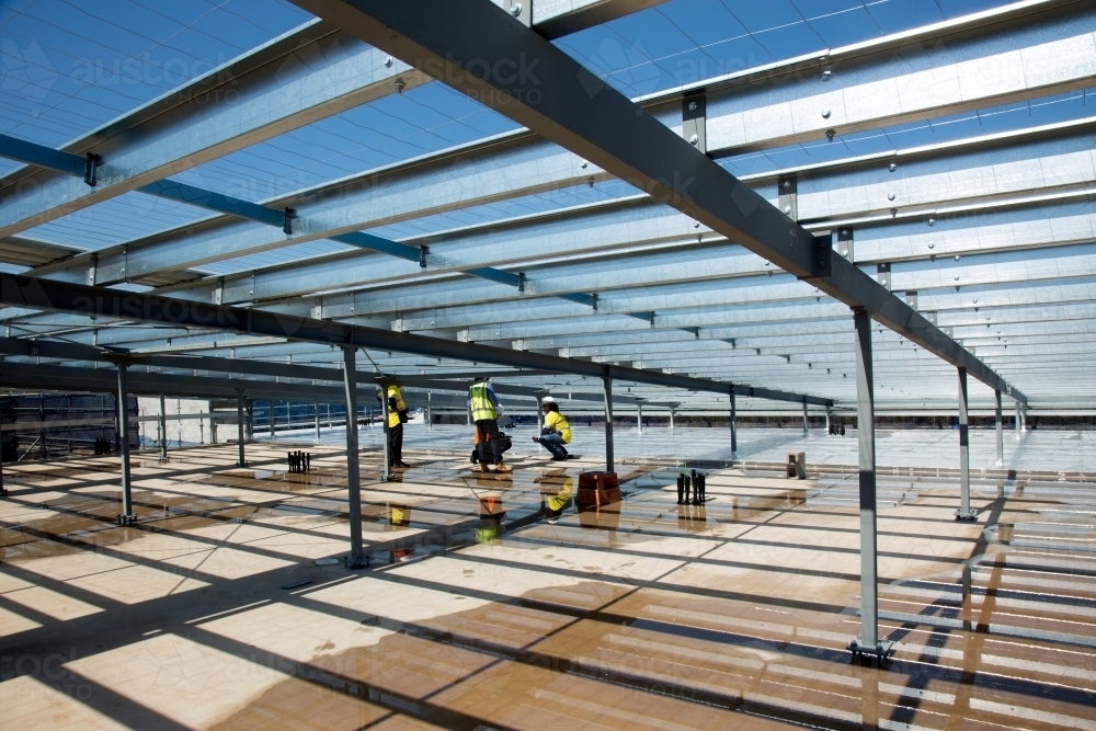 Metal framework and workers on an industrial building site - Australian Stock Image