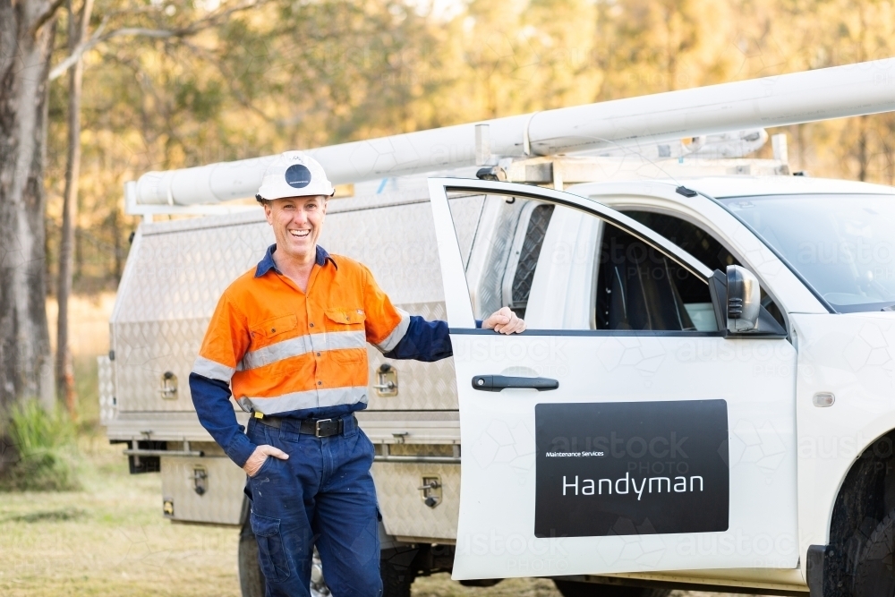 Middle age man and his ute happy to be working for himself as handyman - Australian Stock Image