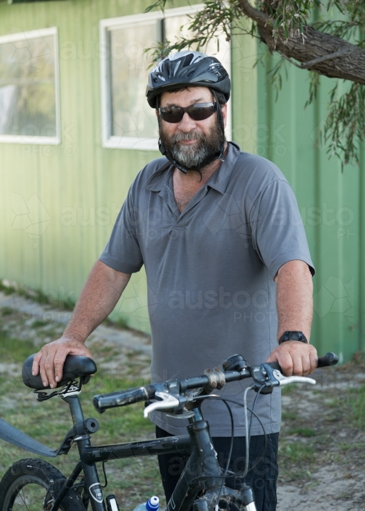 Middle-aged man with bicycle and helmet - Australian Stock Image
