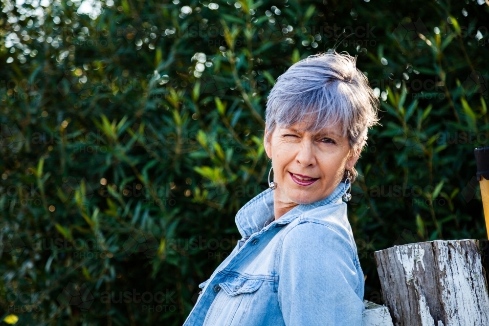 Middle aged woman winking and pulling fun faces - Australian Stock Image