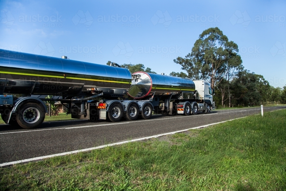 Milk tanker driving past on country road - Australian Stock Image