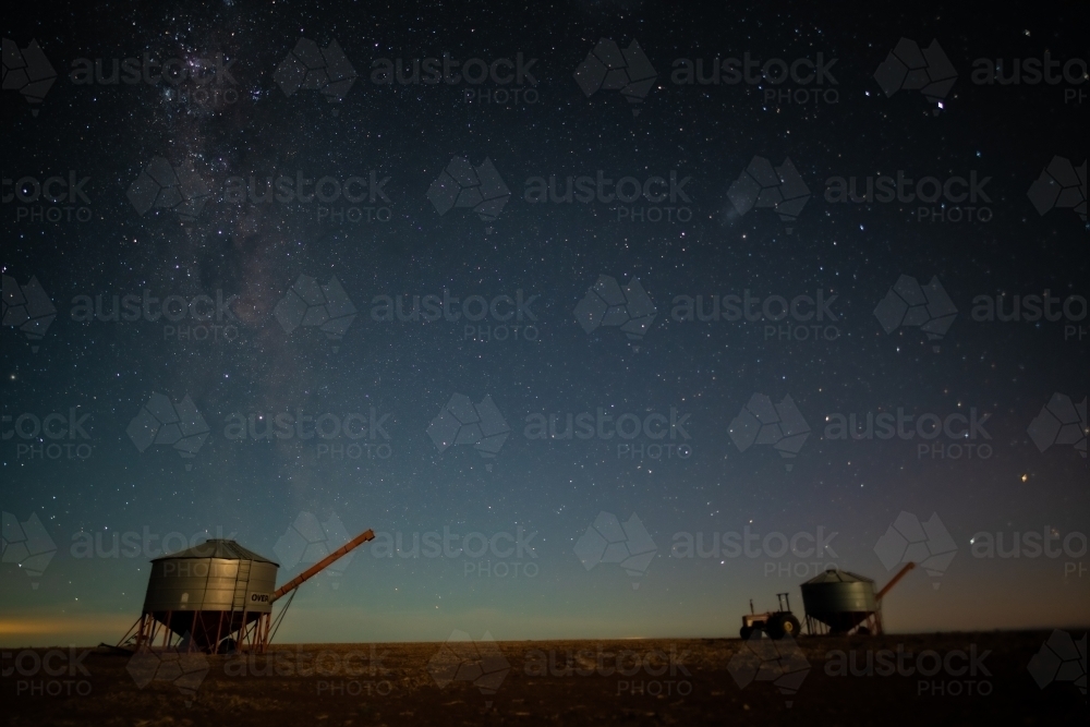 Milky Way setting behind two farming containers in the Australian night sky. - Australian Stock Image