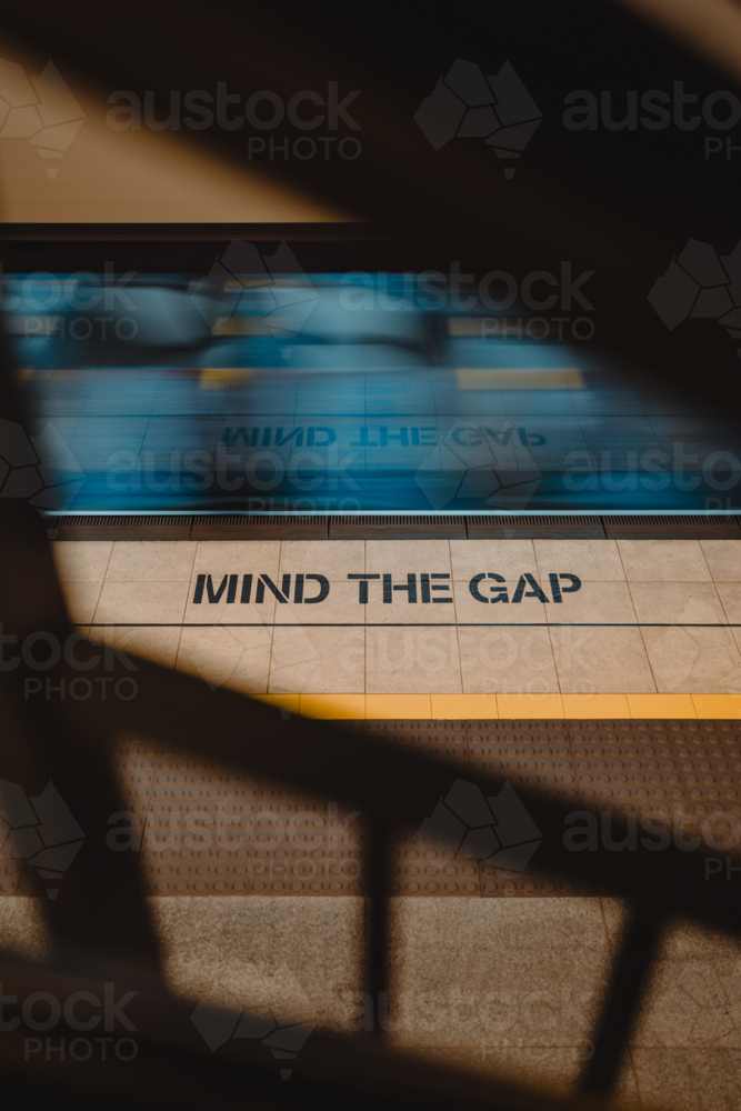 Mind the gap messaging on a train platform in Sydney - Australian Stock Image