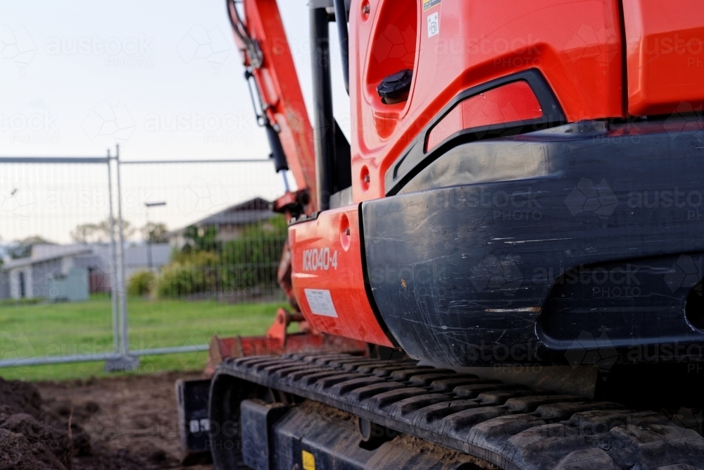 Mini Digger standing idle at a construction site, heavy machinery - Australian Stock Image