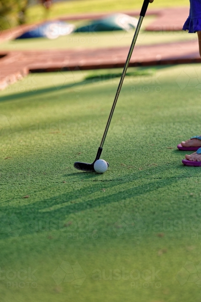 Mini golf or putt-putt green with iron and ball for children - Australian Stock Image
