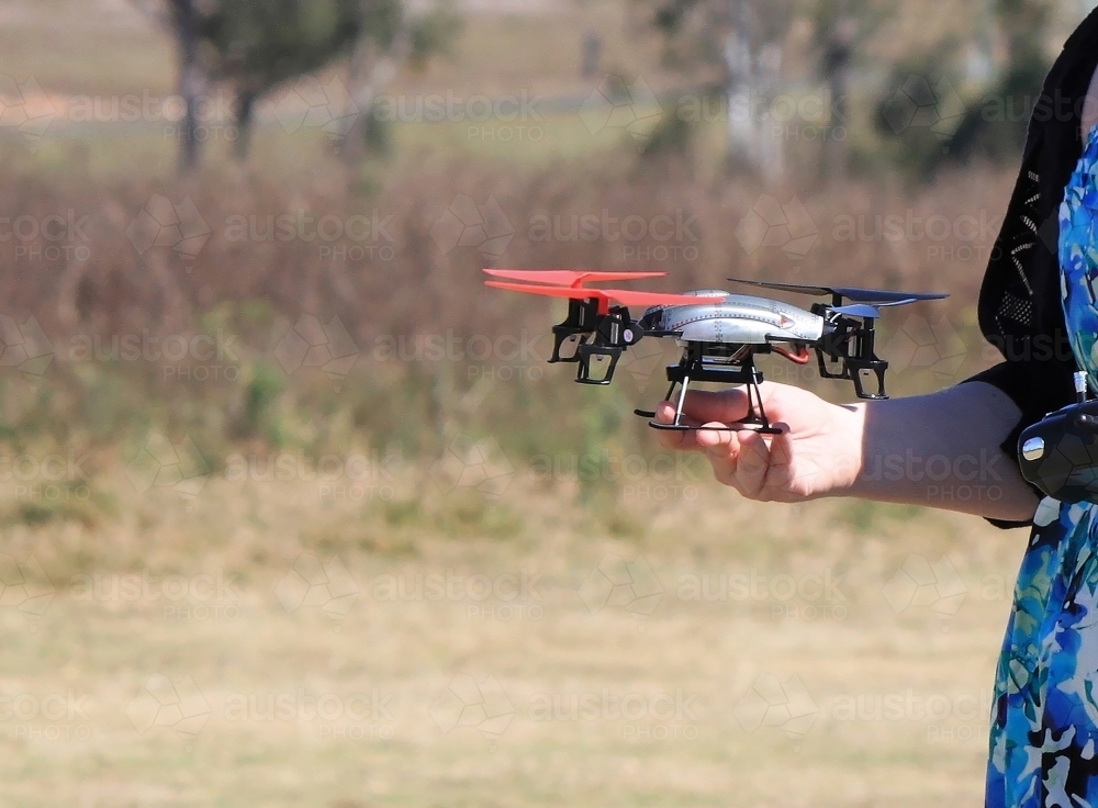 Mini UAV held by a woman in her hand before take off - Australian Stock Image